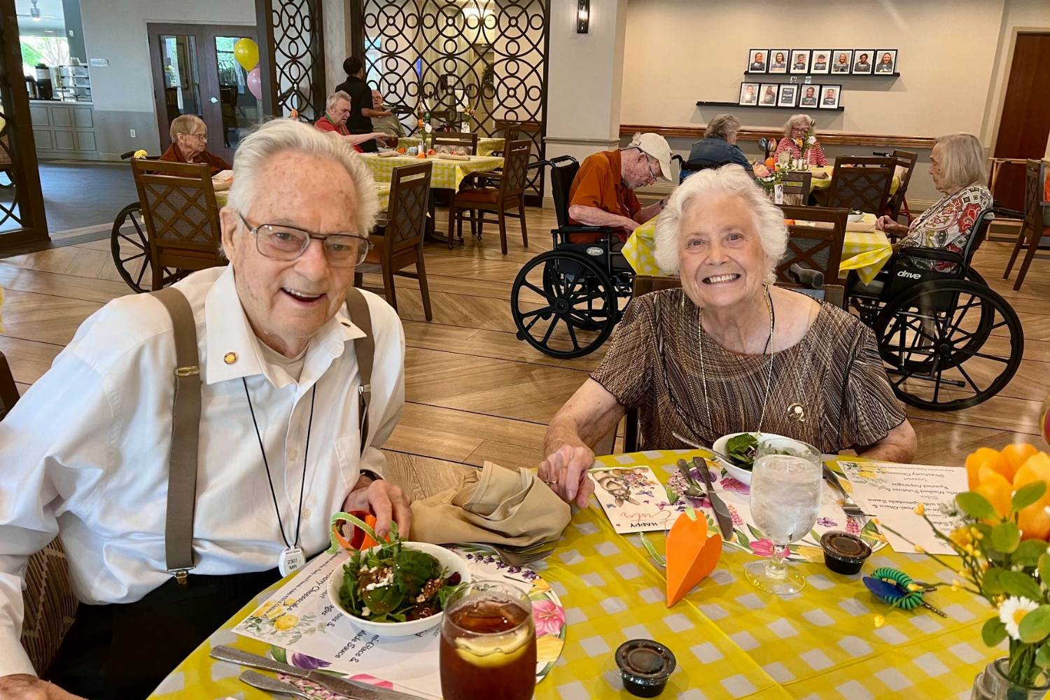Two residents sit together at a cheerfully decorated Easter table at this assisted living community in Lakeway, TX, enjoying the festive holiday atmosphere and warm community spirit at Arbor Terrace.