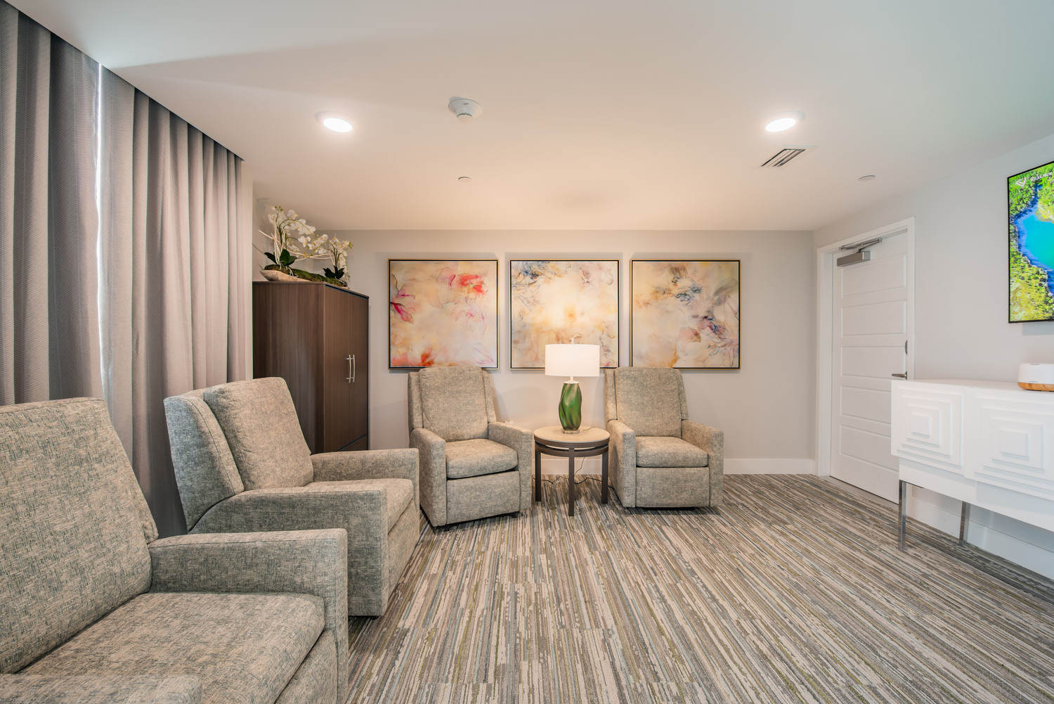 Serene salon and spa lounge at Mirabelle senior living in Miami, FL, featuring plush seating, soft lighting, and calming neutral décor.