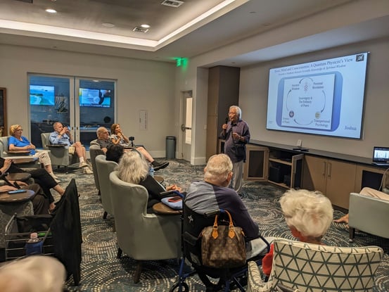 Residents gathered in a cozy meeting room for an educational seminar, reflecting the enriching learning opportunities available at a premier senior living community in Miami, FL.