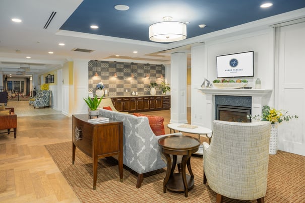  Common area with white walls, wooden floors, and sofas