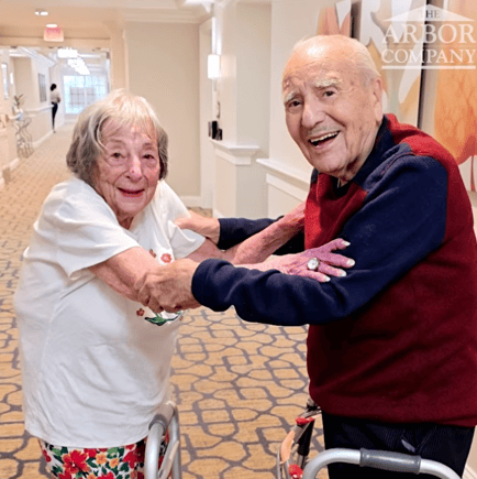 Two senior residents dancing at Arbor Terrace Monmouth.