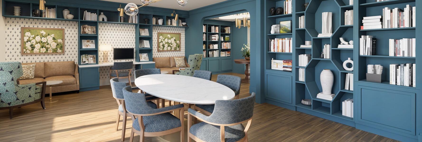 A bright library and meeting room at Arbor Terrace Montgomery features floor-to-ceiling blue bookshelves, a round table, and comfortable seating, offering an inviting space for senior living in Skillman NJ.