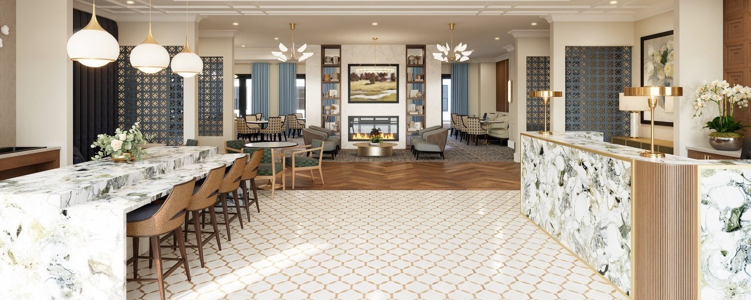 A beautifully designed lobby and common area at Arbor Terrace Montgomery features marble countertops, warm wood flooring, and elegant furnishings, welcoming residents and visitors to this senior living community in Skillman NJ.