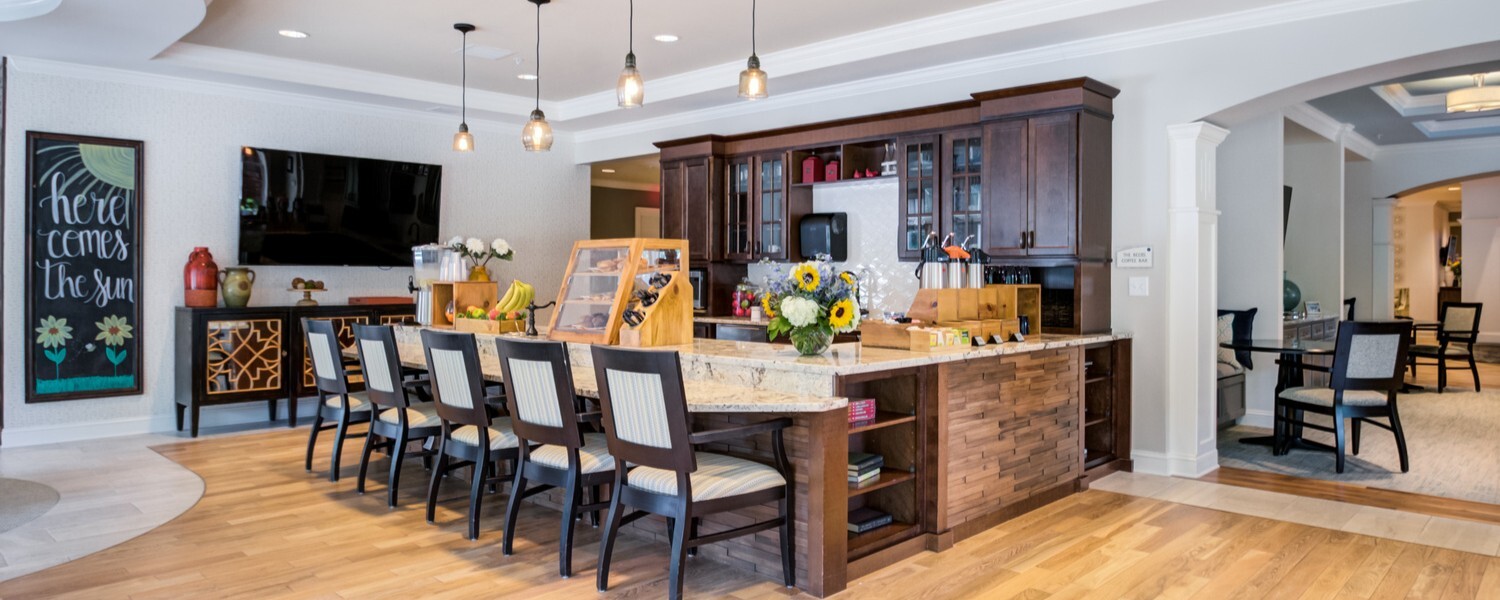 Bar area at Arbor Terrace Morris Plains, a senior living community in New Jersey, featuring an elegant design with seating for social gatherings and a cozy, upscale atmosphere.