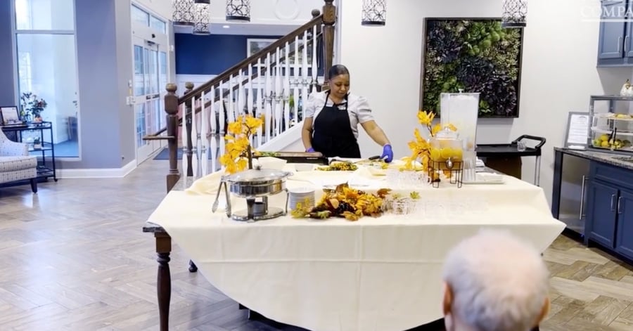 A staff member prepares a live cooking demonstration for residents at our senior living Mountainside NJ community, reflecting the engaging, wellness-focused senior living Mountainside dining experience.