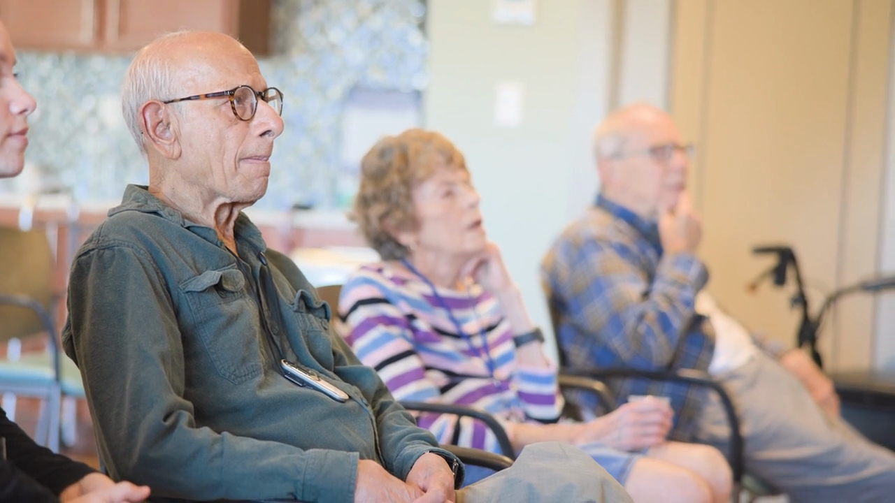Residents attentively engaged during a group activity at our senior living community in Naperville, IL, reflecting the warm, person-centered care and active senior lifestyle that defines daily life here.