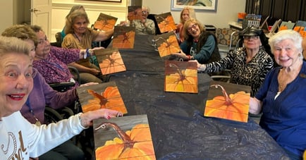a group of seniors with fall-themed paintings