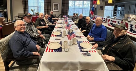 Residents enjoying a meal together for veterans day