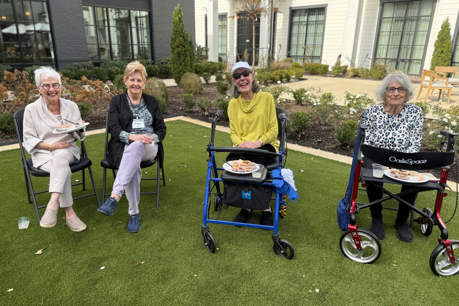 4 Opus East Memphis residents sitting with chili at chili cookoff