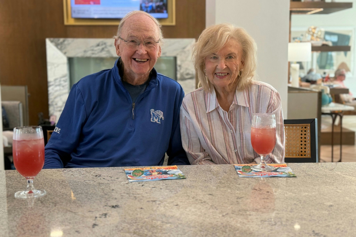 Senior man and woman at Opus East Memphis sitting at table for happy hour