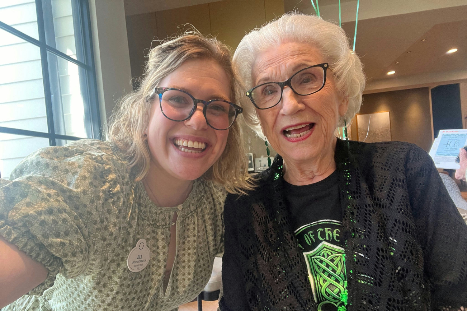 Senior lady and team member smiling for a selfie