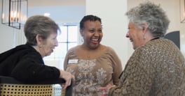 Resident Women and Staff members smiling and laughing