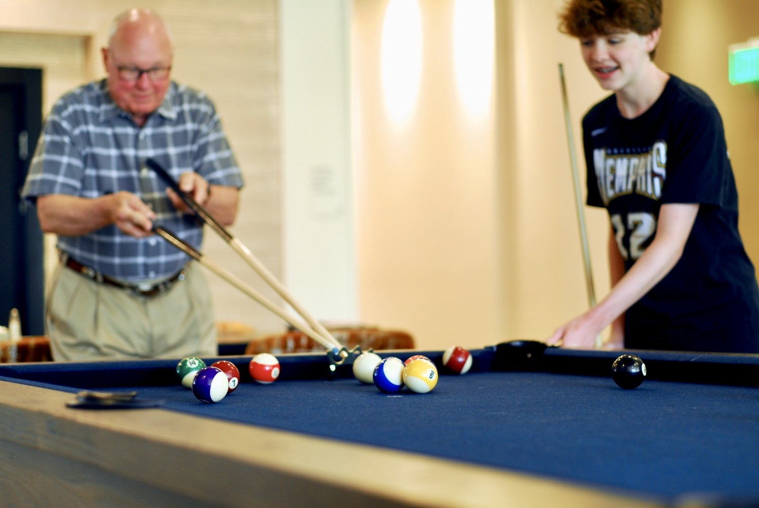 Opus East Memphis resident and grandson playing pool
