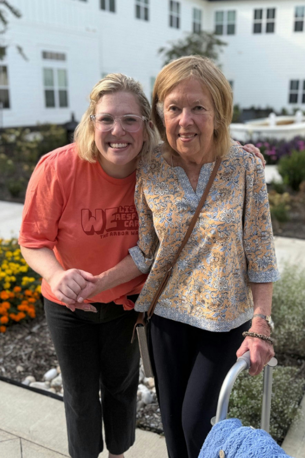 Opus East Memphis - a senior resident and staff smiling while at the garden