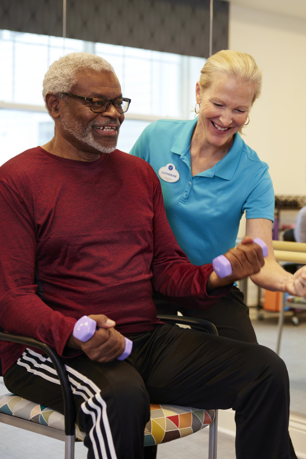 Opus East Memphis - a senior resident being assisted by exercise coach