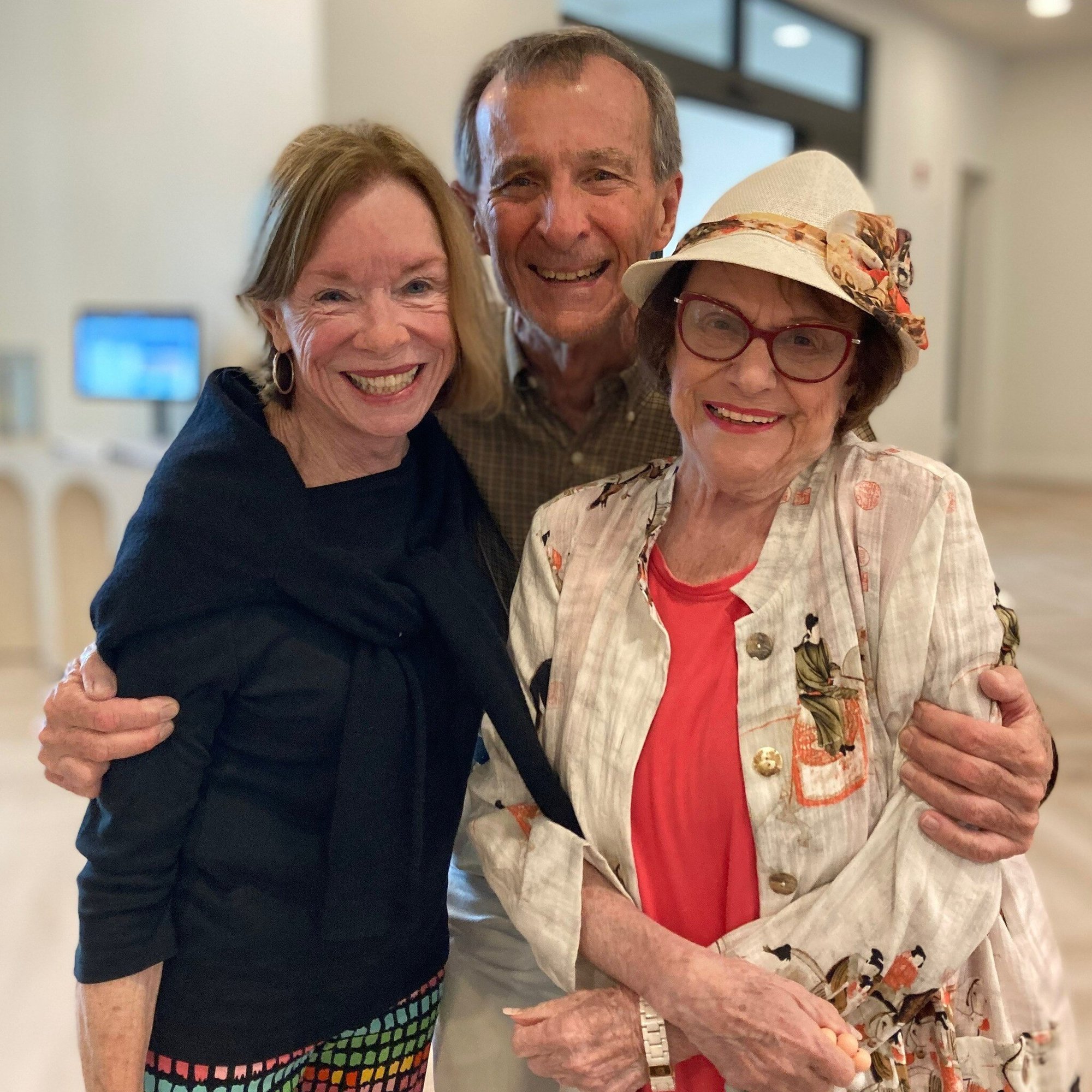 Three people smile warmly together at Opus East Memphis, capturing the close friendships and welcoming community spirit of senior living in East Memphis, TN.
