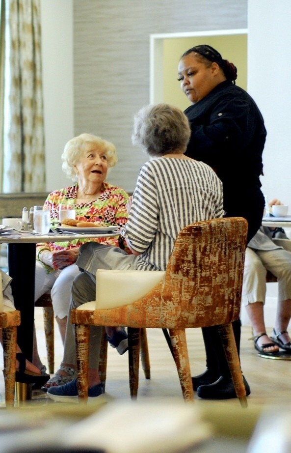 Seniors sitting at a dining table at Opus East Memphis