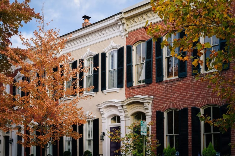 Historic brick buildings framed by autumn foliage capture small-town Virginia charm, reflecting the welcoming feel that assisted living Dumfries VA families experience near senior living Woodbridge VA.