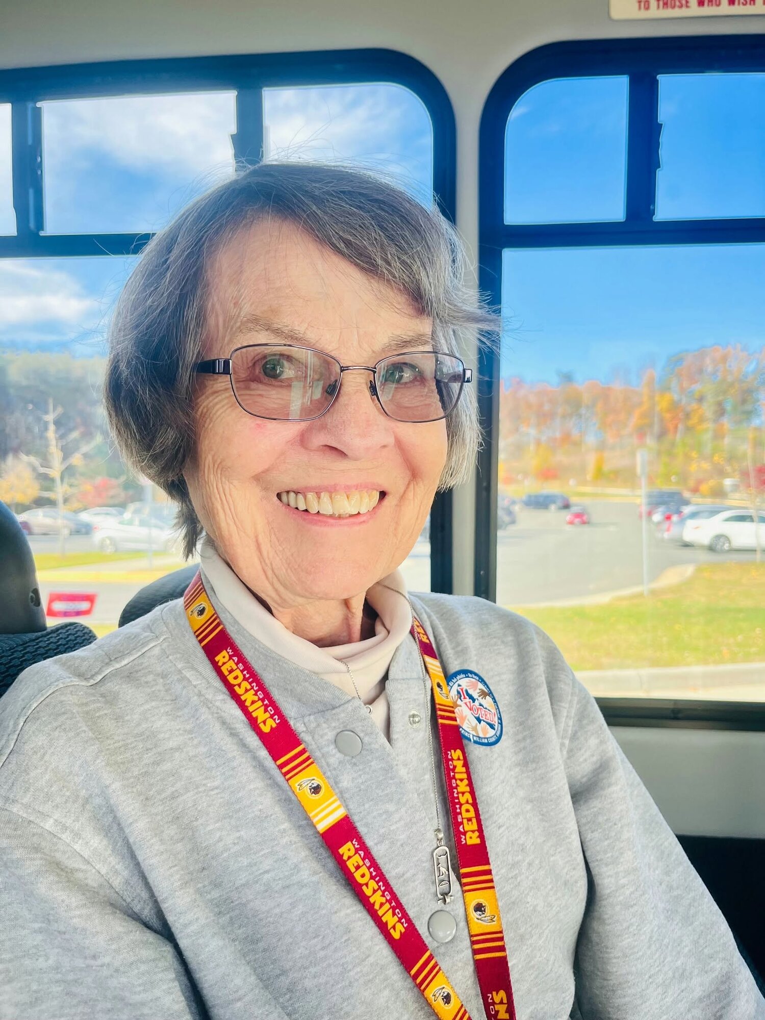 A resident smiles warmly while riding the community shuttle on a scenic outing, highlighting the active senior community Prince William County lifestyle and convenient charm of senior living near me.