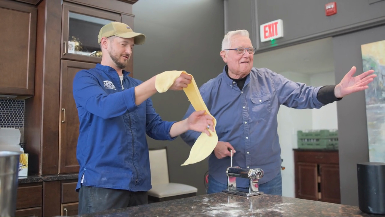 Summit of Uptown - Senior man preparing homemade pasta with chef