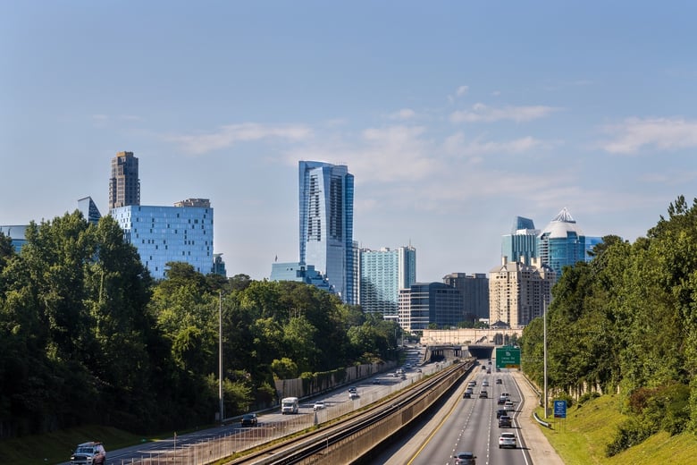 A hazy dusk skyline showcases modern high-rises rising above the city, reflecting the vibrant senior living in North Atlanta, GA and Sandy Springs, GA.