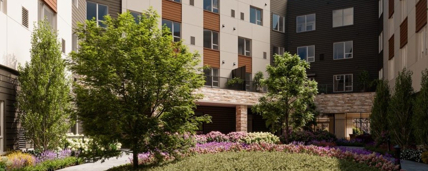 A modern community building exterior features a landscaped courtyard with blooming flowers and mature trees, showcasing the resort-style senior amenities in Sandy Springs, GA.