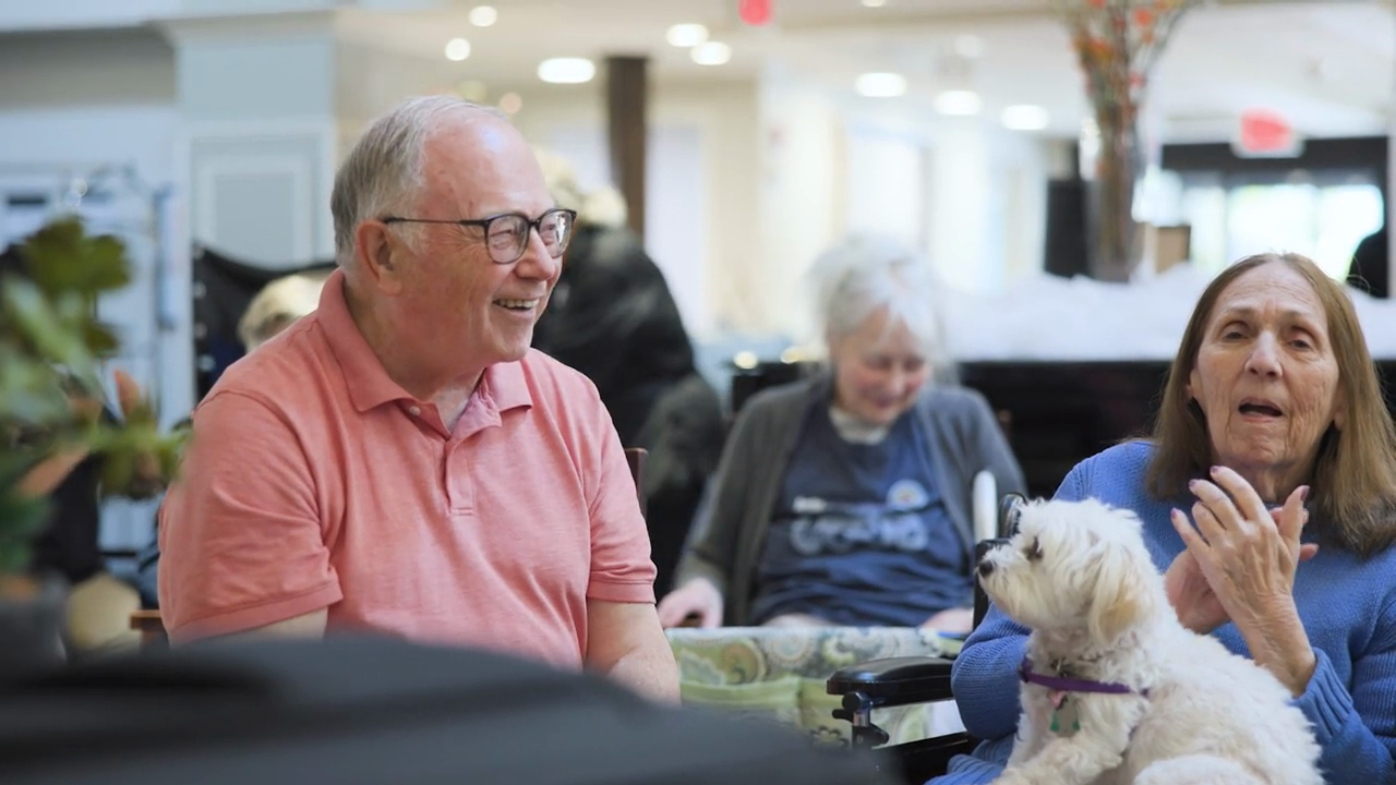 A group of seniors singing and clapping together
