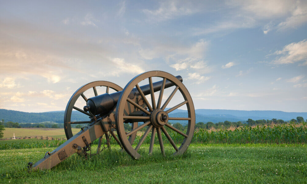 A historic cannon rests in a sunlit field, representing the rich local history near senior living in Dunwoody, GA and Roswell, GA.