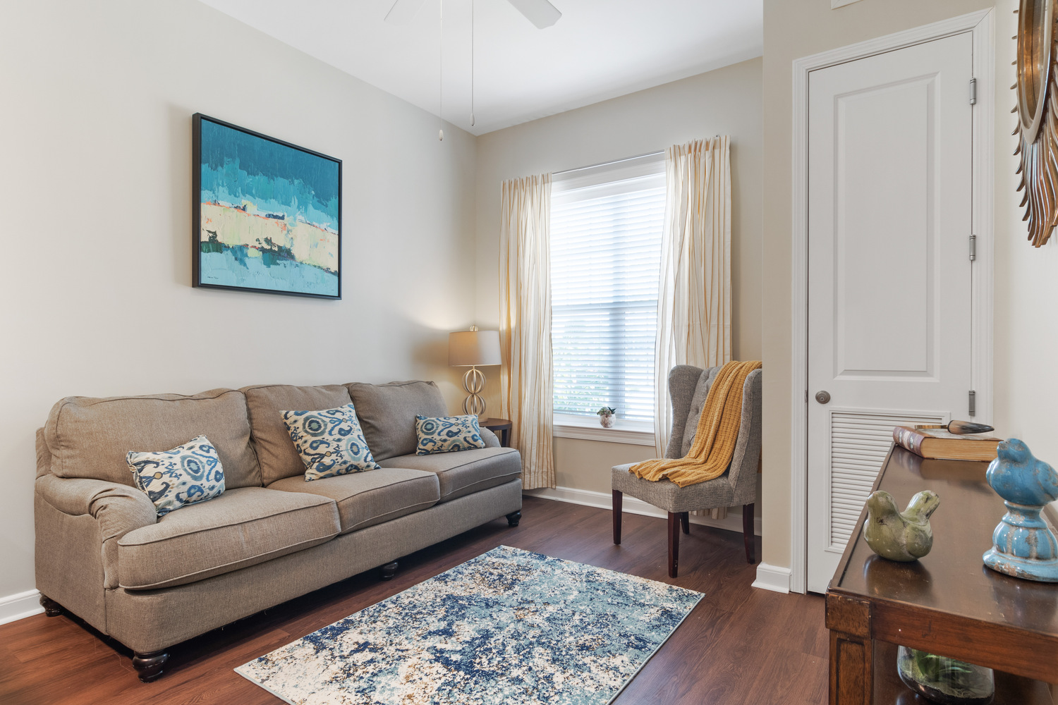A bright, comfortable apartment living room with neutral furnishings and natural light at Arbor Terrace, an assisted living community in Suwanee, GA.