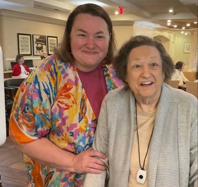 Two women smiling warmly together at Arbor Terrace South Forsyth, capturing the welcoming community spirit of senior living in Suwanee, GA.