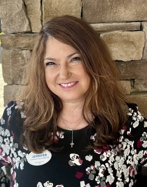 A staff member smiles warmly for a professional headshot at Arbor Terrace, a trusted assisted living community in South Forsyth.