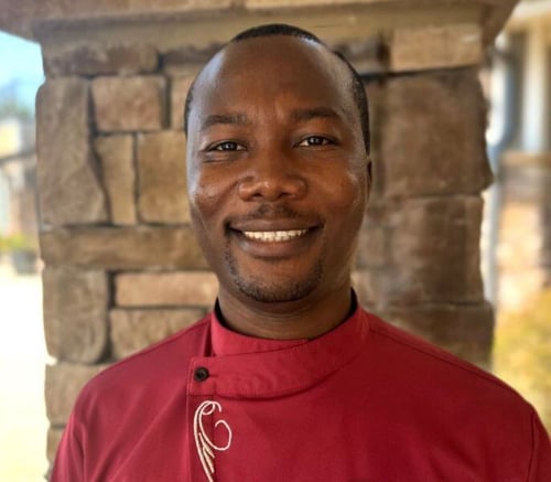 A staff member smiles warmly for a professional headshot at Arbor Terrace, a caring assisted living community in South Forsyth.