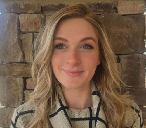 A smiling staff member poses for a professional headshot at Arbor Terrace, a caring assisted living community in Dacula, GA.