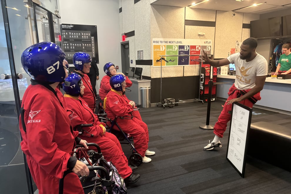 arbor-terrace-sudley-manor-seniors-learning-indoor-skydiving-hand-signals