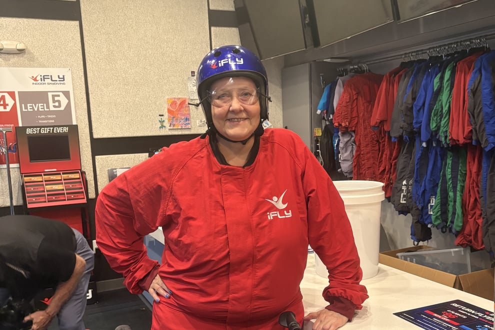 arbor-terrace-sudley-manor-smiling-senior-in-flight-suit-and-helmet