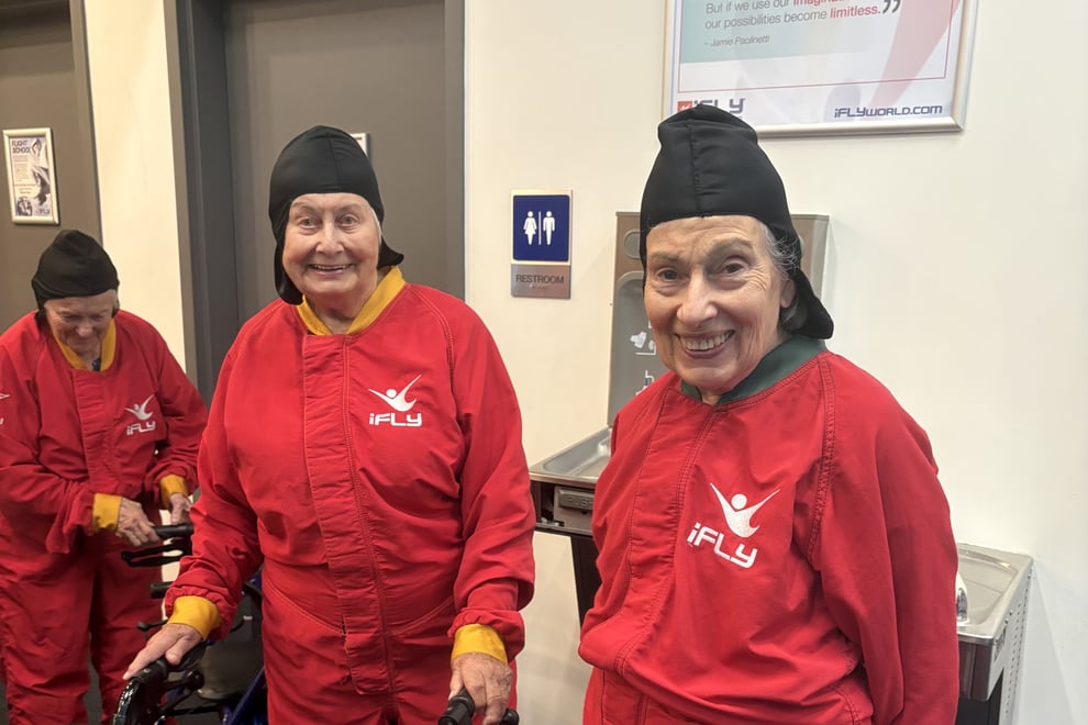 arbor-terrace-sudley-manor-smiling-seniors-in-flight-suits-and-caps