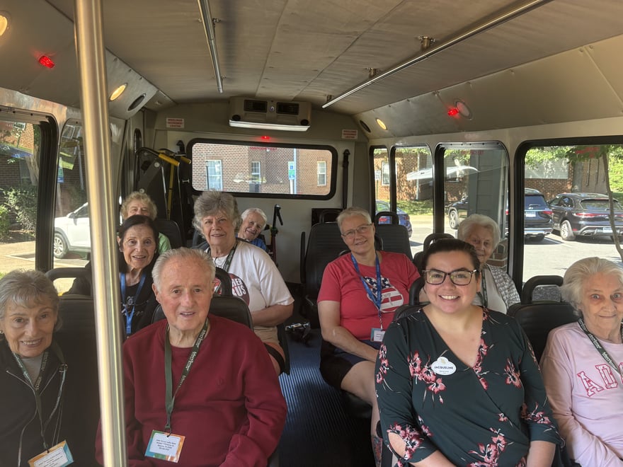 arbor-terrace-sudley-manor-smiling-seniors-riding-shuttle-bus-to-outing