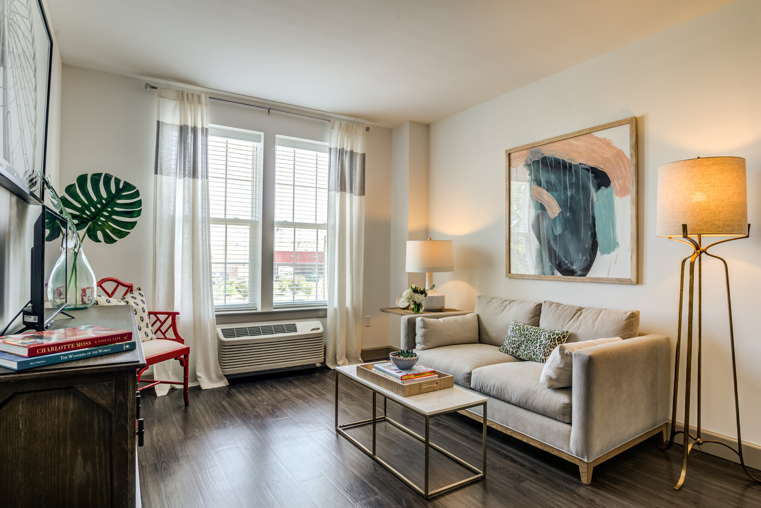 A sunlit apartment sitting area at Arbor Terrace Waugh Chapel featuring stylish furnishings, large windows, and elegant décor, capturing the warm and refined atmosphere of this boutique assisted living community in Gambrills, MD.