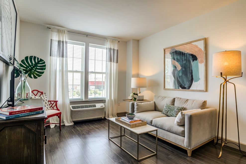 Living room area with a couch, coffee table, and lamps