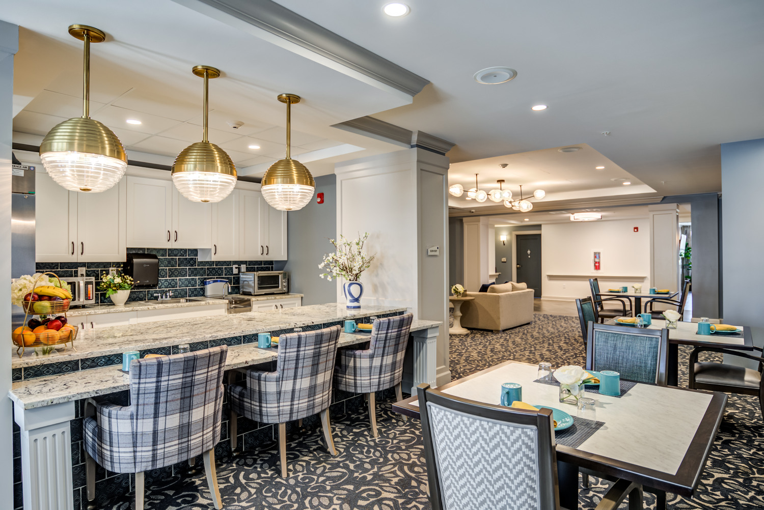 A spacious, elegantly set community dining area at Arbor Terrace Waugh Chapel featuring pendant lighting, patterned flooring, and ample seating, reflecting the resort-style dining experience available at this senior living community in Anne Arundel County.