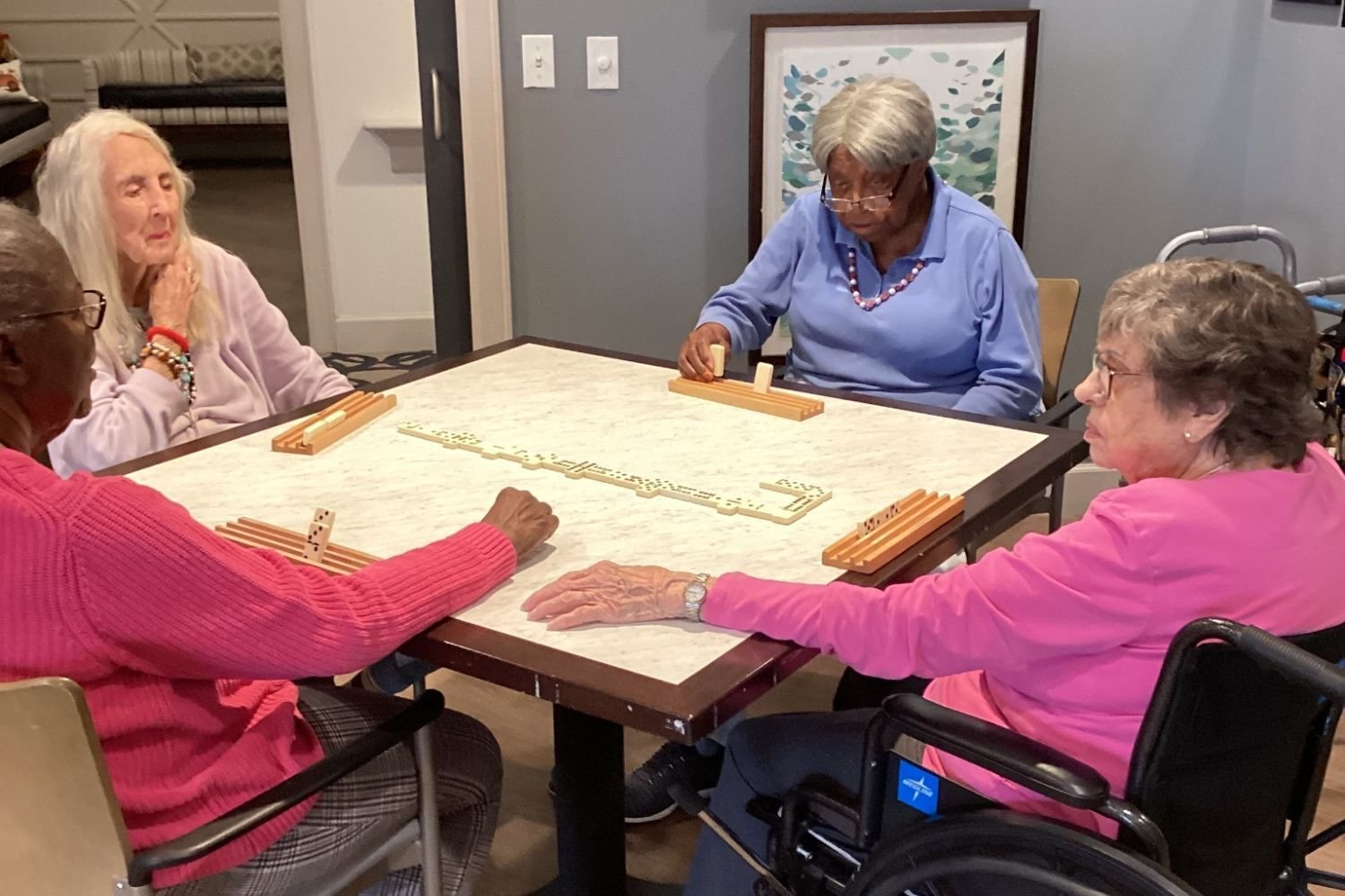 Residents engage in a tabletop activity together at Arbor Terrace Waugh Chapel, highlighting the enriching and socially engaging lifestyle programs that support connection and wellness at this assisted living community in Gambrills, MD.