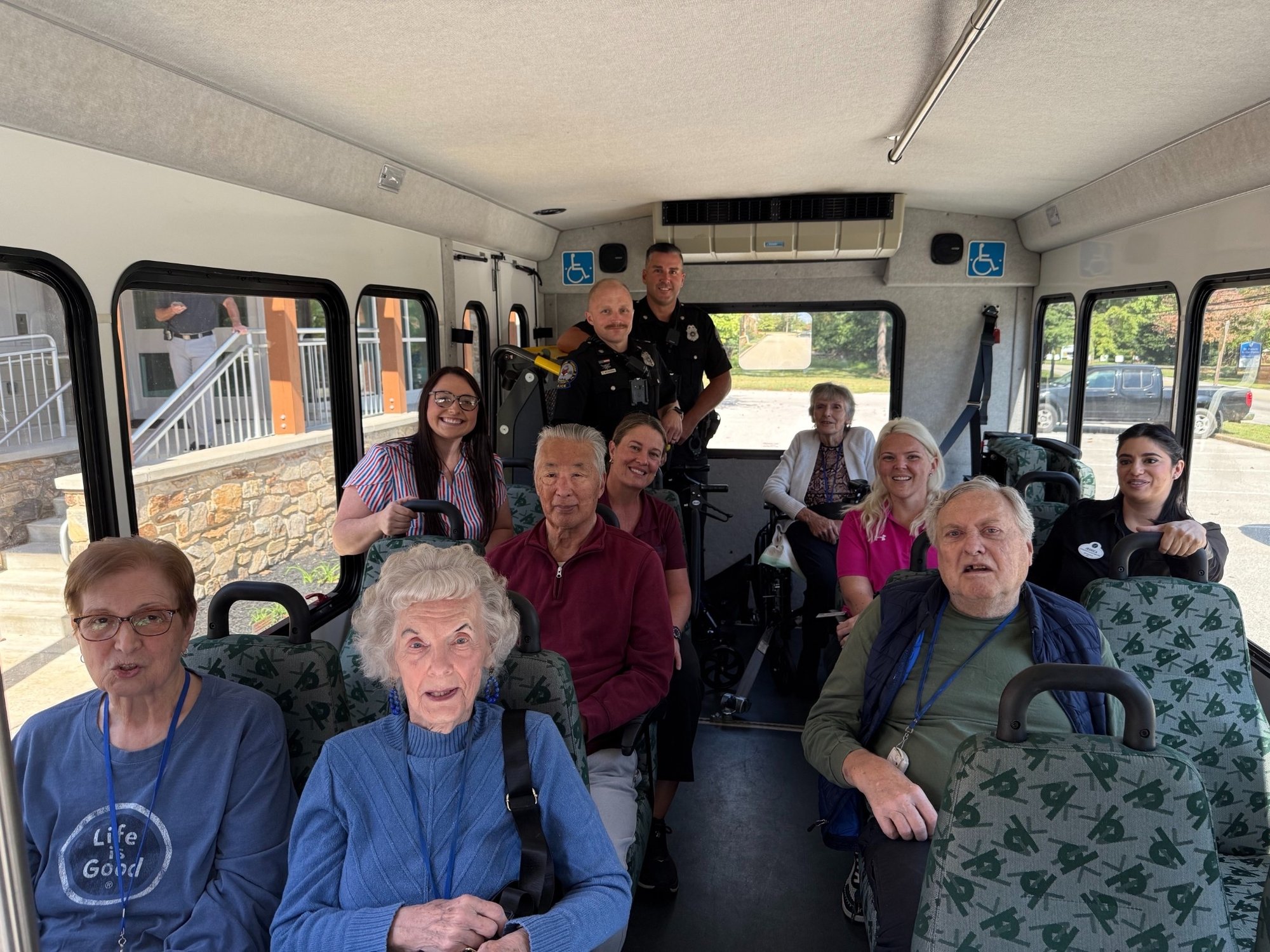 A group of senior living residents riding a bus
