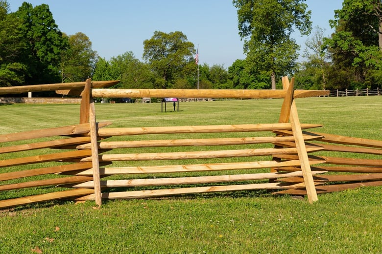 A wooden split-rail fence on an open green field in Malvern, PA, a charming borough near Arbor Terrace Willistown assisted living West Chester PA.