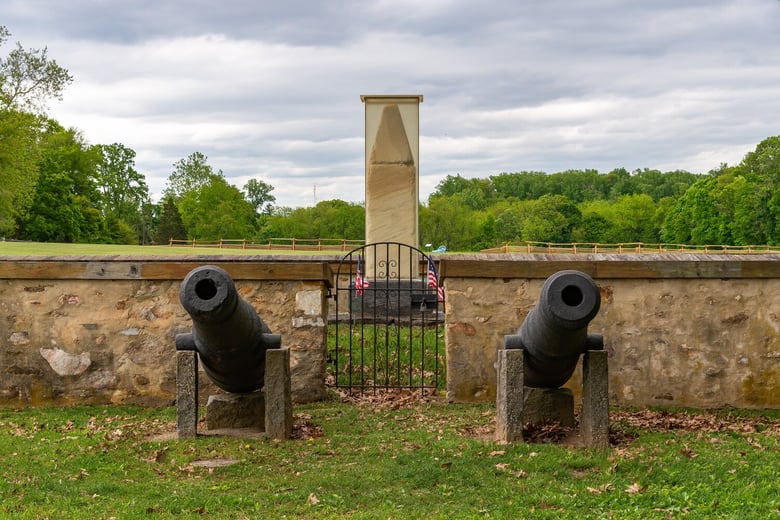 A historic stone monument flanked by cannons in a grassy park in Paoli, PA, near Arbor Terrace Willistown senior living West Chester Pennsylvania.