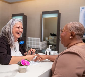 Resident getting a manicure by a staff member
