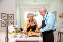 Resident couple prepping for dinner with various vegetables