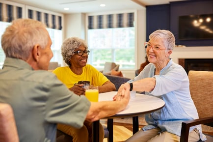 Residents conversing at a table