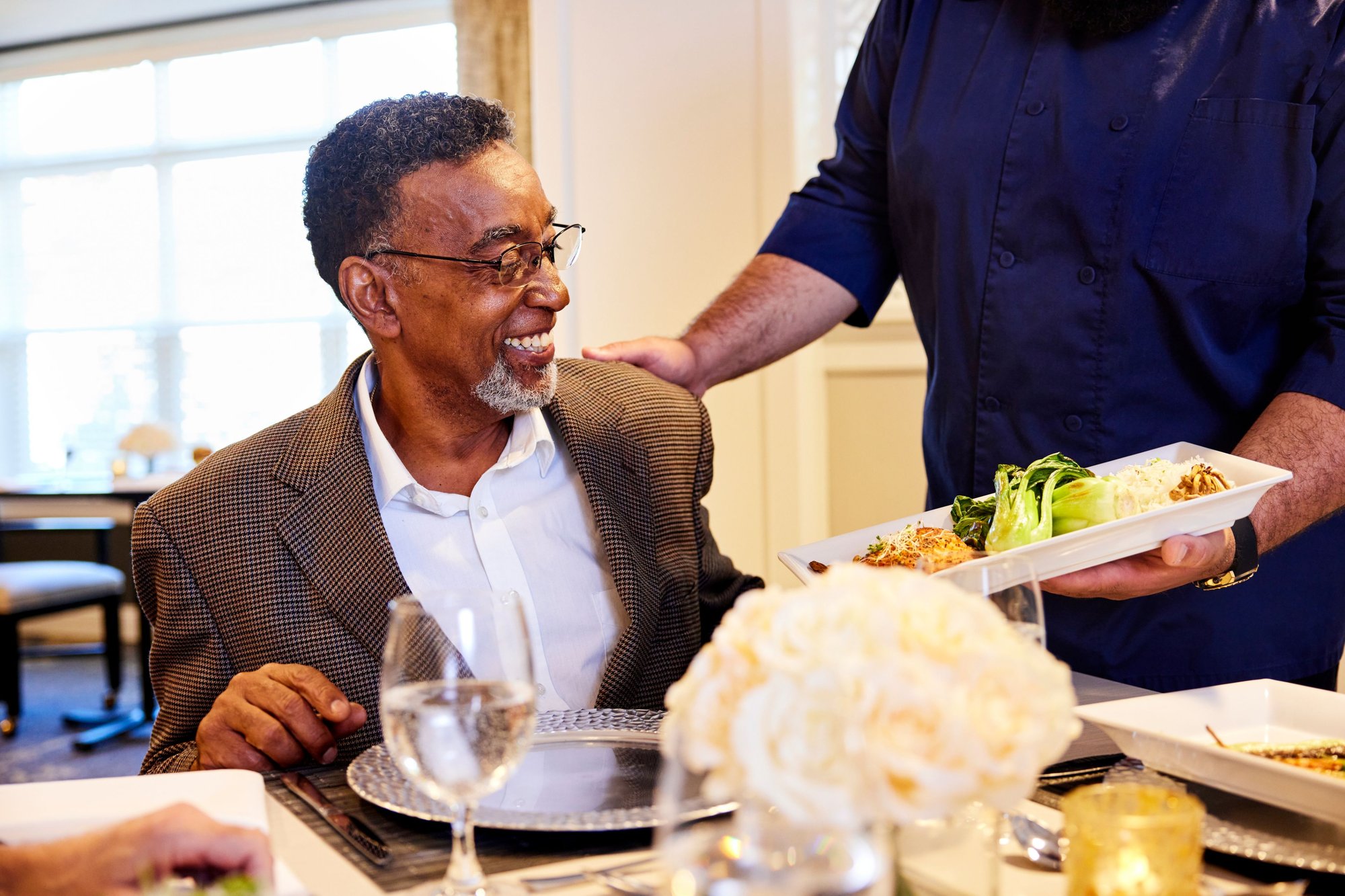 Server handing resident his food