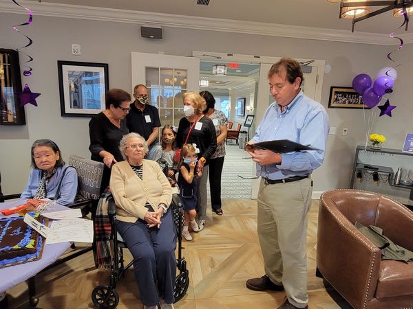 a group of senior residents and family celebrating a party