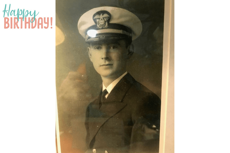 A vintage black-and-white portrait of a young man in a Navy officer's uniform and cap, displayed alongside a birthday greeting, honoring a resident's remarkable life at senior living in Fort Myers, FL.